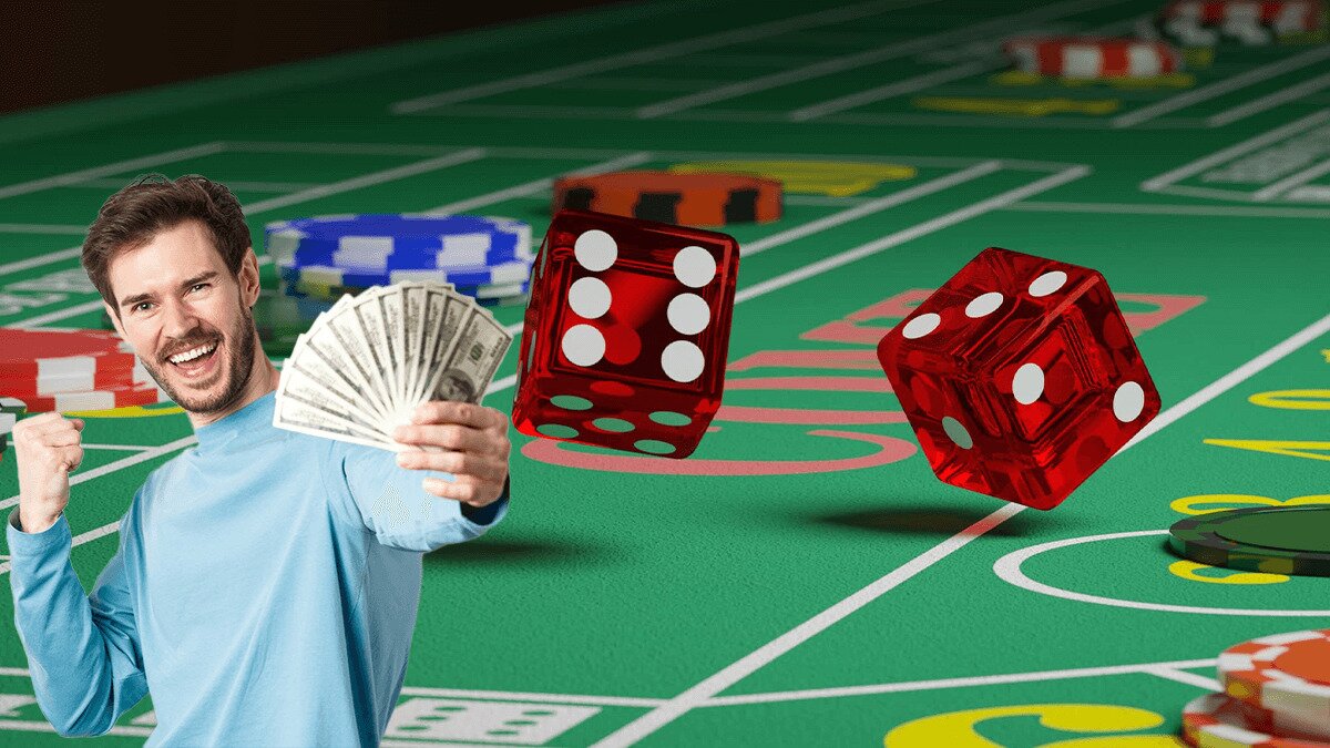 Man holding money next to dice rolling on a craps table