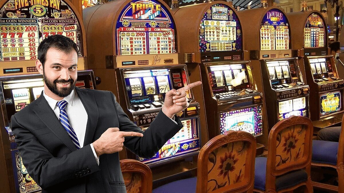 Businessman pointing at a row of slot machines 